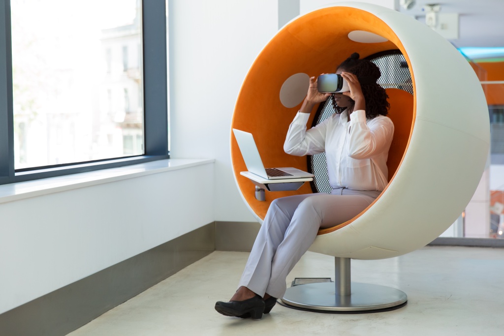 female-office-employee-with-laptop-watching-virtual-presentation.jpg